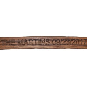 May include: A wooden sign with the text "THE MARTINS 09/23/2017" engraved on it.