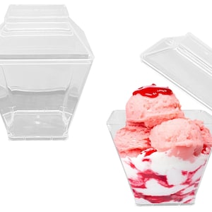 May include: Clear plastic dessert cups with lids. The cups are square shaped and have a pointed top. The lids are dome shaped. The cups are filled with pink ice cream and a red sauce.