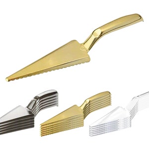 May include: A set of 10 gold plastic cake servers. The servers are stacked on top of each other. The servers are serrated and have a gold handle.