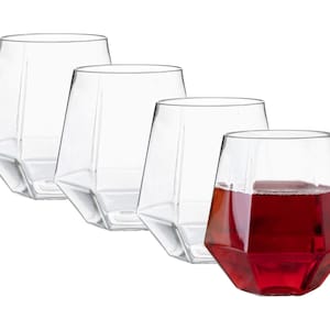 May include: Set of four clear glass tumblers with a geometric design. One tumbler is filled with red wine.