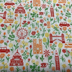 May include: White fabric with a repeating pattern of red and orange London landmarks, including Big Ben, the London Eye, and a double-decker bus. The pattern also includes red and orange flowers and green leaves.