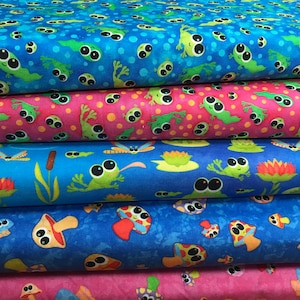 May include: A stack of colourful fabric featuring cartoon frogs, tadpoles, and mushrooms. The fabric has a blue, pink, and teal background with a repeating pattern of the whimsical creatures. The fabric is suitable for quilting and crafting.