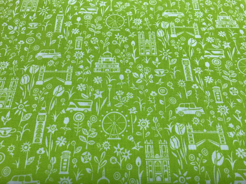 May include: Green fabric with a white repeating pattern of London landmarks, including Big Ben, the London Eye, and a double-decker bus. The pattern also includes flowers, teacups, and other small details.