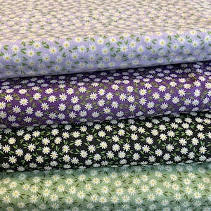 May include: Four fabric samples with a daisy floral pattern. The colours are lavender, purple, black, and green. Each fabric has a repeating pattern of small white daisies with yellow centres and green leaves.