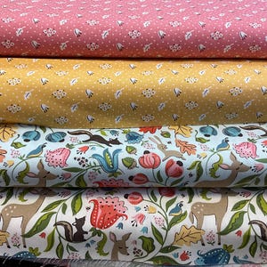 May include: Four rolls of fabric with various patterns. The top two rolls have small white floral and cloud patterns on pink and yellow backgrounds. The bottom two rolls feature woodland animal and floral designs on light blue and white backgrounds.
