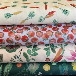May include: Four stacked bolts of fabric featuring vegetable prints. The top bolt has orange carrots on cream. The second has red tomatoes on light blue. The third has artichokes, carrots, and radishes on cream. The bottom has green leaves on dark green.