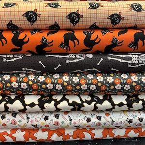 May include: A stack of six different Halloween-themed fabric prints. The prints feature black cats, skeletons, ghosts, pumpkins, and candy. The fabrics are all in various shades of orange, black, white, and green.
