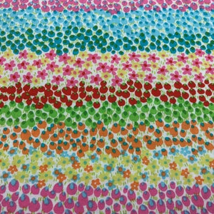 May include: A colorful fabric with a repeating pattern of small flowers, leaves, and berries. The fabric is white with stripes of pink, blue, green, orange, and red.