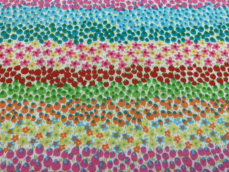 May include: A colorful fabric with a repeating pattern of small flowers, leaves, and berries. The fabric is white with stripes of pink, blue, green, orange, and red.