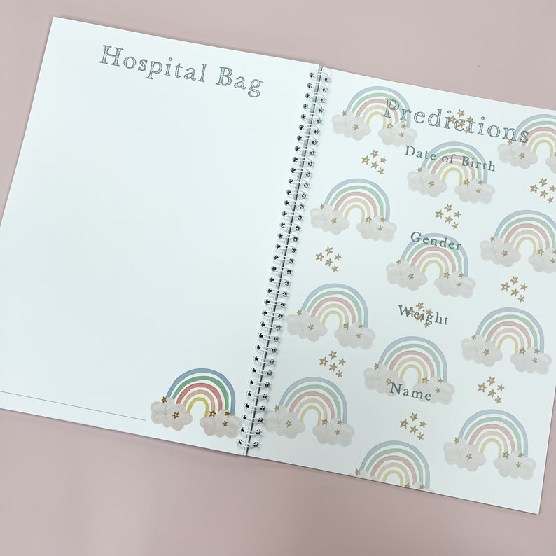 May include: A white spiral bound book with a rainbow and star pattern on the cover. The book has the title "Predictions" and includes sections for "Date of Birth", "Gender", "Weight", and "Name".