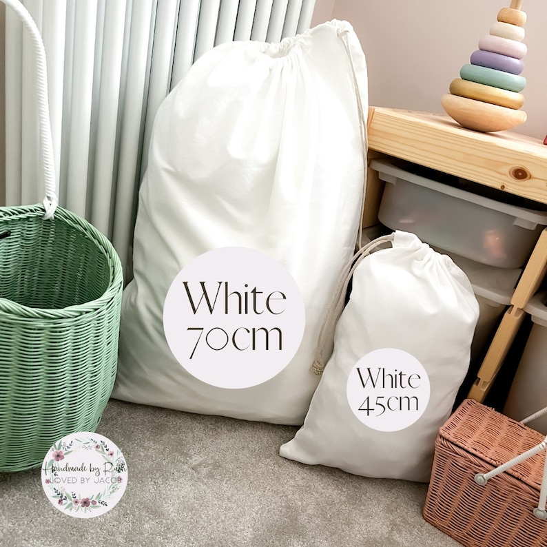 May include: Two white cotton drawstring bags with labels. The larger bag is labeled "White 70cm" and the smaller bag is labeled "White 45cm".