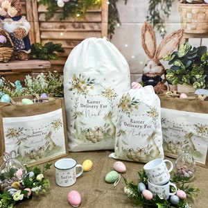 May include: A set of four personalized Easter gift bags with bunny illustrations and the text "Easter Delivery For" followed by a name. The bags are surrounded by pastel-colored Easter eggs and green foliage.