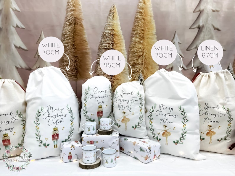 May include: Four white and one linen Christmas gift bags with personalized designs. The bags are decorated with a nutcracker, a ballerina, and greenery. The bags are available in sizes 70 cm, 45 cm, and 67 cm.