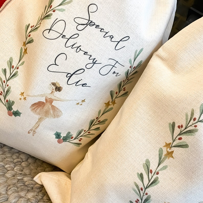May include: A white canvas tote bag with a green and gold floral design and the text "Special Delivery for Eddie". A ballerina illustration is featured in the center of the bag.