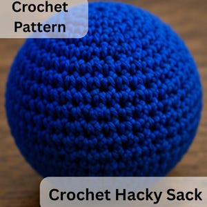May include: A spherical, bright blue crochet hacky sack featuring a dense, uniform stitch pattern. The image includes the text Crochet Pattern and Crochet Hacky Sack overlaid on the object, which is crafted from yarn in a vibrant, solid blue color.
