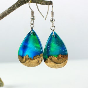 Teardrop earrings handmade with green lab-created opal, wood and resin. Opals iridescent colors shift from blue, green & orange, and the wood texture gives the impression of a mountain peaks.