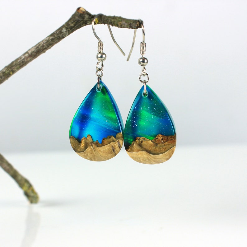 Teardrop earrings handmade with green lab-created opal, wood and resin. Opals iridescent colors shift from blue, green & orange, and the wood texture gives the impression of a mountain peaks.