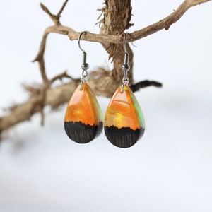 Teardrop earrings handmade with yellow lab-created opal, wood and resin. Opals iridescent colors shift from green, yellow & orange, and the wood texture gives the impression of a mountain peaks.