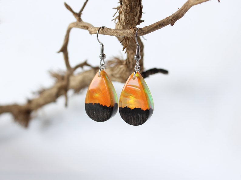 Teardrop earrings handmade with yellow lab-created opal, wood and resin. Opals iridescent colors shift from green, yellow & orange, and the wood texture gives the impression of a mountain peaks.