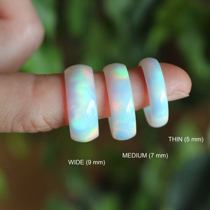 Three width options of handcrafted ring made of lab grown opal that changes colors with movement. Iridescent glow adds a unique touch. Lightweight and comfortable to wear.