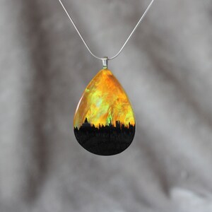 Teardrop pendant handmade with yellow lab-created opal, wood and resin. Opals iridescent colors shift from green, yellow & orange, and the wood texture gives the impression of a mountain peaks.