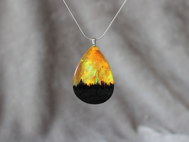 Teardrop pendant handmade with yellow lab-created opal, wood and resin. Opals iridescent colors shift from green, yellow & orange, and the wood texture gives the impression of a mountain peaks.