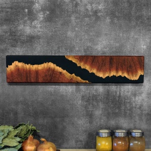 Wall hanging magnetic knife holder made of pieces of burl wood, in combination with black resin. Perfect gift for chefs & cooking enthusiasts.