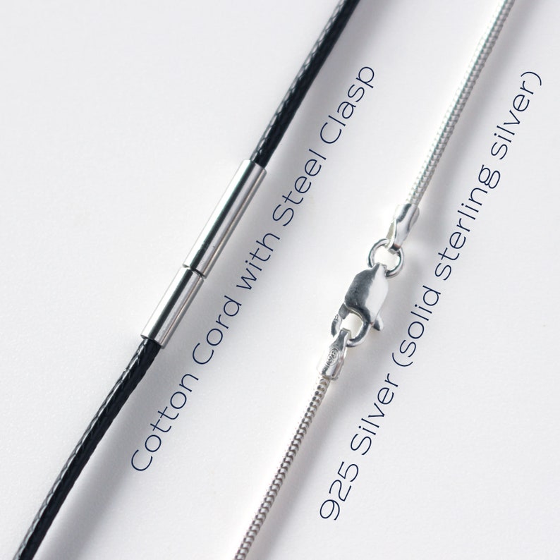 May include: Close-up of two necklace chains. One is a black cotton cord with a steel clasp. The other is a 925 silver chain. Text on the image reads "Cotton Cord with Steel Clasp" and "925 Silver (solid sterling silver)".