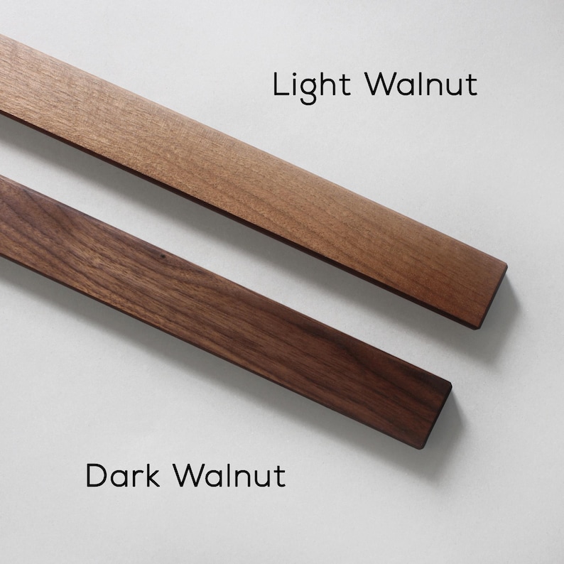May include: Two wooden strips, one light walnut and one dark walnut, showing the color difference between the two wood types.