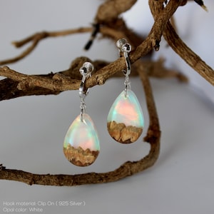 Teardrop earrings handmade with white lab-created opal, wood and resin. Opals iridescent colors shift from white, blue, green, orange, pink & more, and the wood texture gives the impression of a mountain peaks.