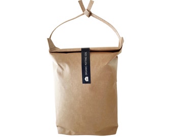 May include: A brown paper bag with a black label that says "ORGANIC POTTING SOIL". The bag has a string handle and is tied at the top.