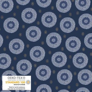 May include: A navy blue fabric with a repeating pattern of white and blue circular designs. The circles have a textured appearance and are evenly spaced across the fabric. Small gold-colored floral accents are scattered between the circles. The fabric has the Oeko-Tex Standard 100 label.