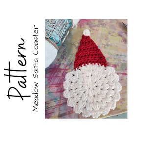 May include: A handmade crochet Santa Claus coaster with a red hat and white beard. The coaster is round and has a textured appearance. The word "Pattern" is written vertically in black on the left side of the image.