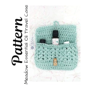 May include: A crocheted teal essential oil travel case with a wooden clasp. The case is open and has three small bottles inside.