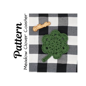 May include: A green crocheted clover coaster with a wooden tag that says "@ltkcuties" on a black and white checkered background. The text "Pattern Meadow Clover Coaster" is written vertically on the left side of the image.