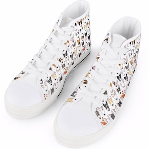 May include: White high-top canvas sneakers with a pattern of colorful bull terrier dog faces.