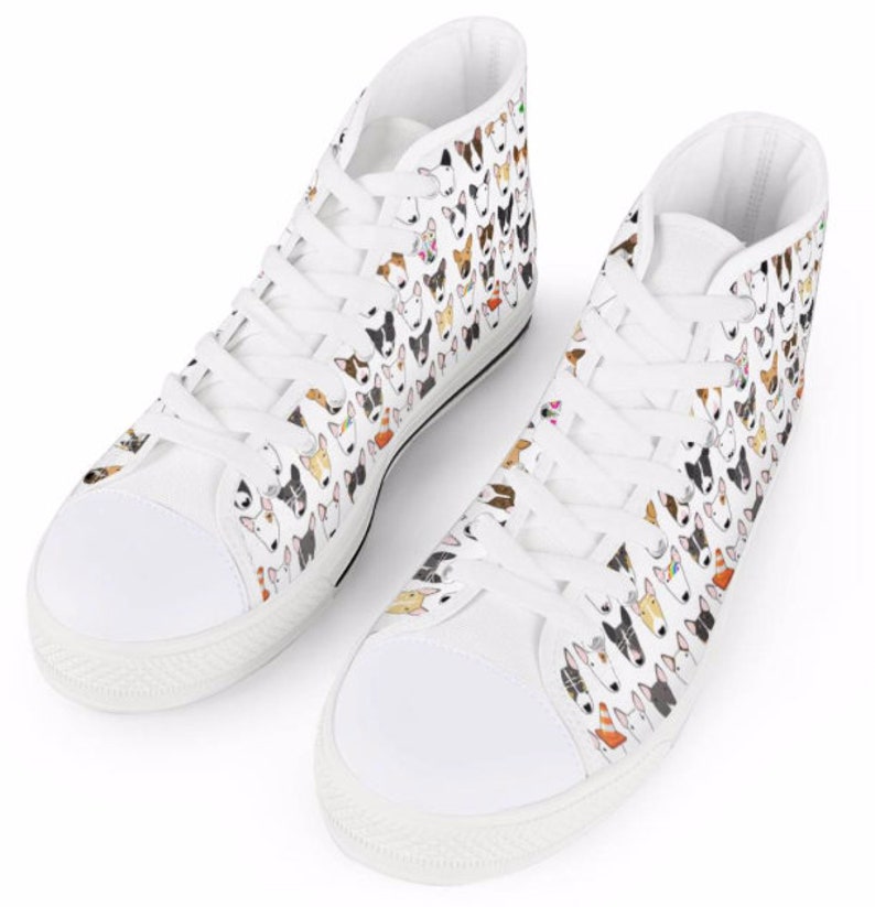 May include: White high-top canvas sneakers with a pattern of colorful bull terrier dog faces.