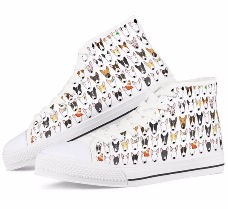 May include: White high-top canvas sneakers with a pattern of colorful bull terrier dog faces.