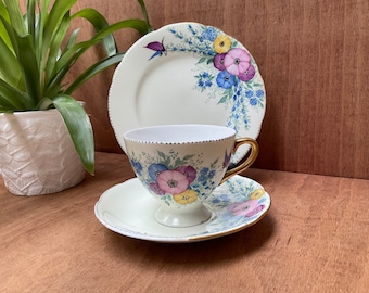 Hand painted vintage tea trio, signed by M.W. Superbly hand decorated by the Glaswegian artist May Wilson. c1920.