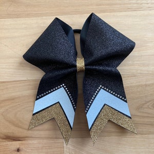 Gorgeous Black, White and Gold Cheer Bow with Rhinestones at the bottom. Price listed is per individual bow. Black cheer bow, black comp bow