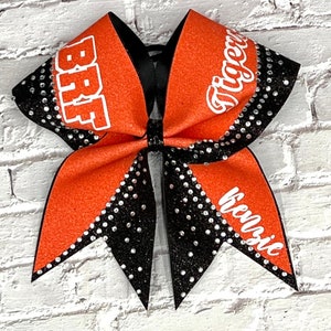 The Anna glitter cheer bow with rhinestones price is listed per individual bow. Gorgeous cheer bows. Competition bows, team bows.