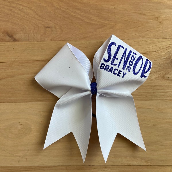 White Autograph Cheer Bow with or without writing on top loop. Price listed is per individual bow. Indicate color of writing at checkout.