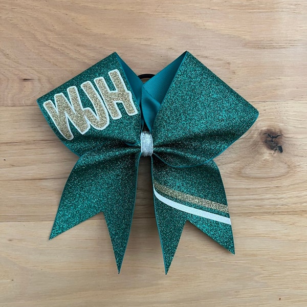 All glitter cheer bow with team initial or team name. Bows made in your team colors. Price listed is per individual bow. Glitter cheer bows