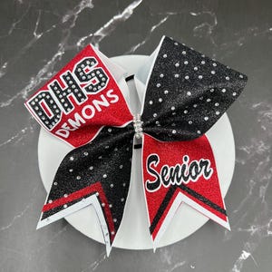 Cami Custom Cheer Bows designed in your team colors. Price listed Is per Individual bow. Glitter team cheer bow, cheer bow, competition bow.