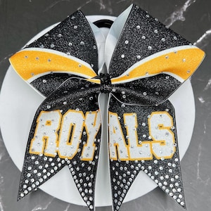 Custom glitter cheer bow covered in rhinestones. Bows made in your teams Colors. Price lIsted is per individual bow.