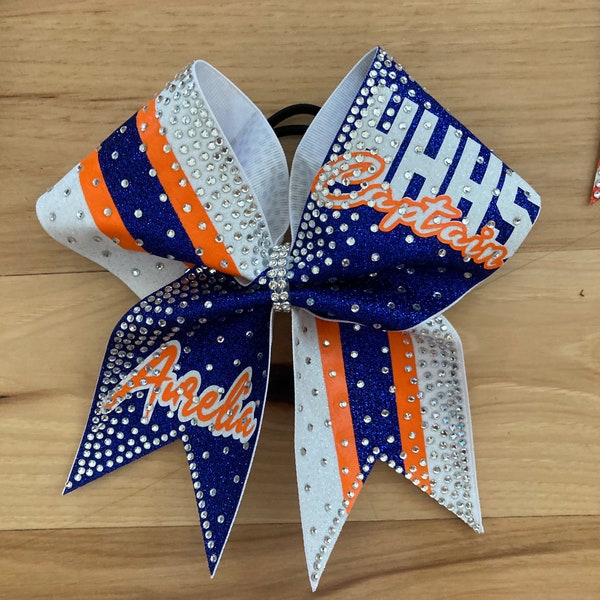 The Gaucho Custom glitter cheer bow covered in rhinestones. Bows made in your teams Colors. Price lIsted is per individual bow. Comp bow