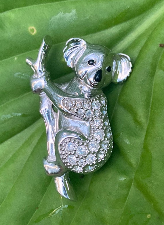 Swarovski Koala Holding a Branch Brooch. Silver Tone with Black Eyes and Nose and Clear Crystals. Swan Logo