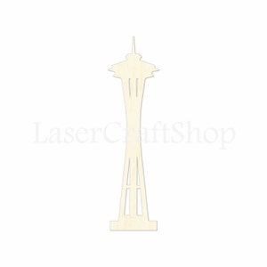 May include: A laser-cut wooden cutout of the Space Needle, a famous landmark in Seattle, Washington. The cutout is made of light brown wood and has a detailed design.