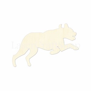 May include: A wooden cutout of a dog running, in a light beige color. The dog is in a leaping pose with its legs extended.