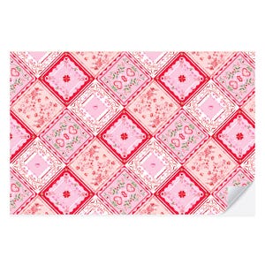 May include: A pink and red patterned wrapping paper with a repeating design of hearts, flowers, and squares. The paper has a vintage, romantic feel.